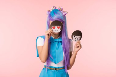 Anime girl in purple wig holding emoticons isolated on pink clipart