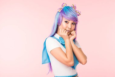 Pretty asian anime girl in purple wig posing isolated on pink clipart
