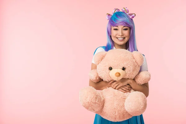 Sorrindo Asiático Anime Menina Peruca Segurando Ursinho Isolado Rosa — Fotografia de Stock