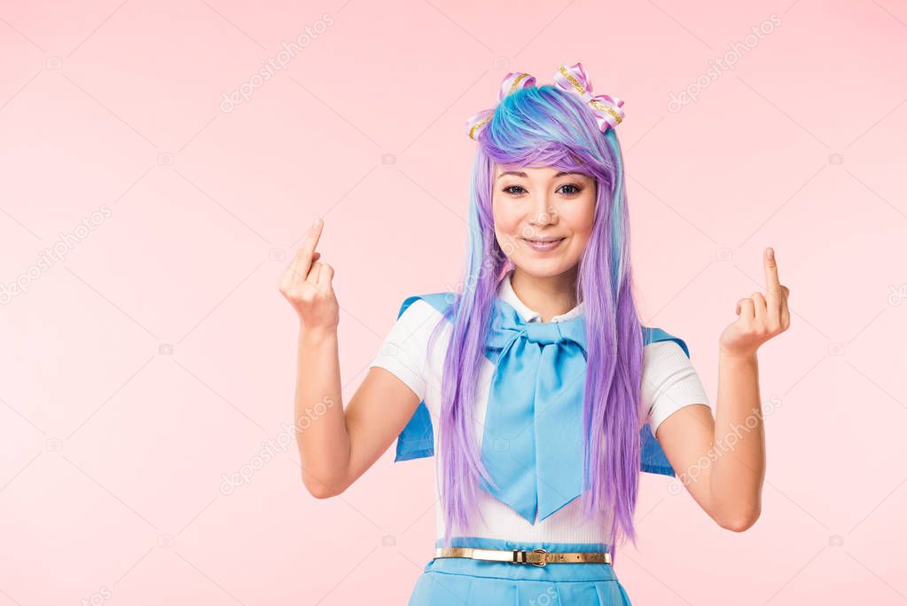 Asian anime girl in purple wig showing middle fingers isolated on pink