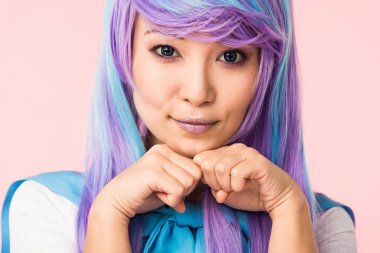 Asian anime girl in wig posing isolated on pink clipart
