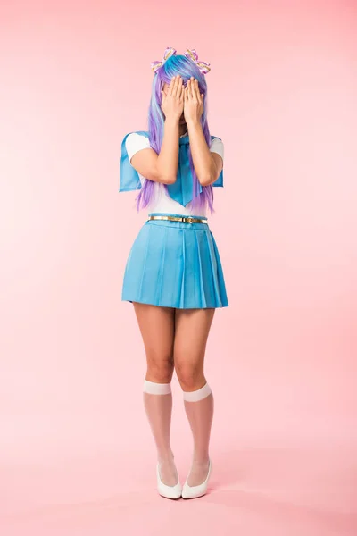Full length view of anime girl in blue skirt covering eyes with hands on pink