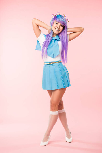 Full length view of otaku girl in purple wig smiling on pink