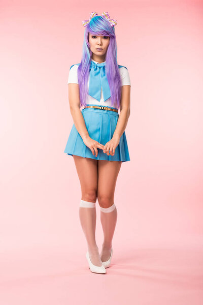 Full length view of sad asian anime girl in skirt standing on pink