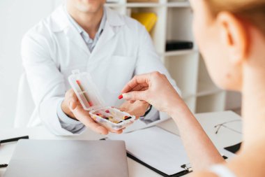 kadın yakın hapları ile kutu tutan doktor kırpılmış görünümü 
