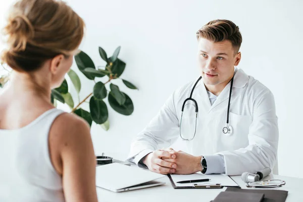 Selective Focus Doctor White Coat Sitting Clenched Hands Looking Patient — Stock Photo, Image