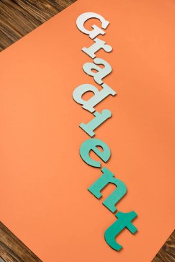 gradient word made of green letters on bright orange paper  clipart