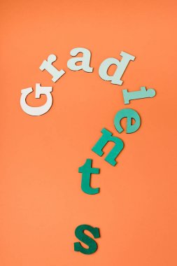 top view of colorful letters on orange surface clipart