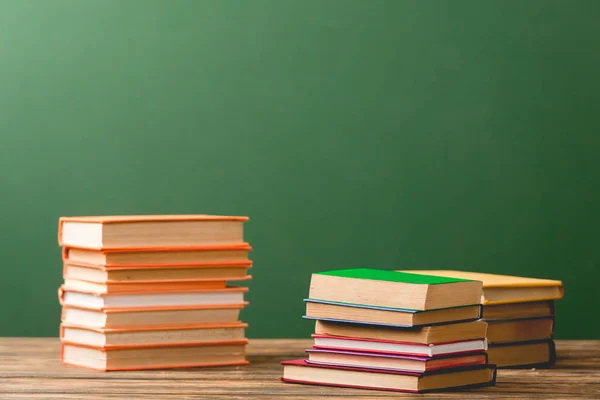 Stacks Colorful Books Wooden Surface Green — Stock Photo, Image