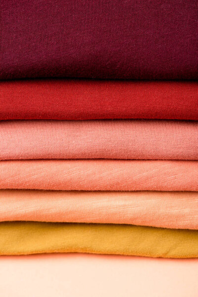 close up view of stack of folded colorful clothes