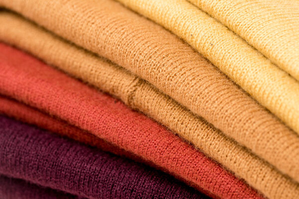 close up view of stack of folded colorful clothes