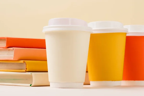 Stack Books Colorful Disposable Cups White Surface Isolated Beige — Stock Photo, Image