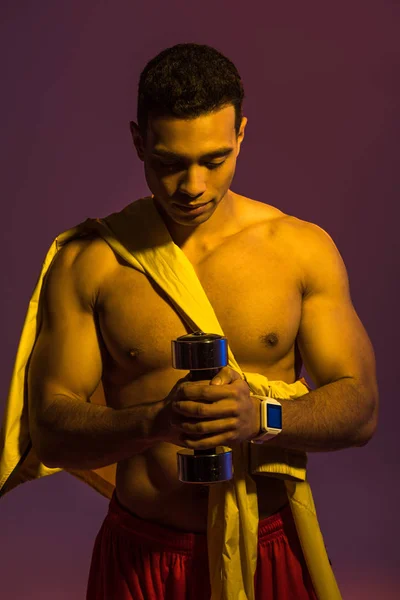 Sportive Mixed Race Man Muscular Torso Holding Dumbbell Purple Background — Stock Photo, Image