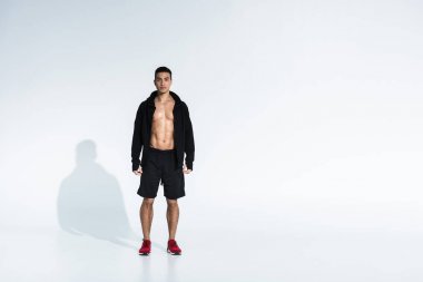 siyah spor ceket, şort ve beyaz arka plan üzerinde kırmızı spor ayakkabı sportif karışık yarış adam
