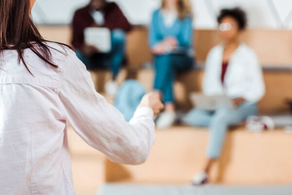 selective focus of students listening teacher in lecture hall