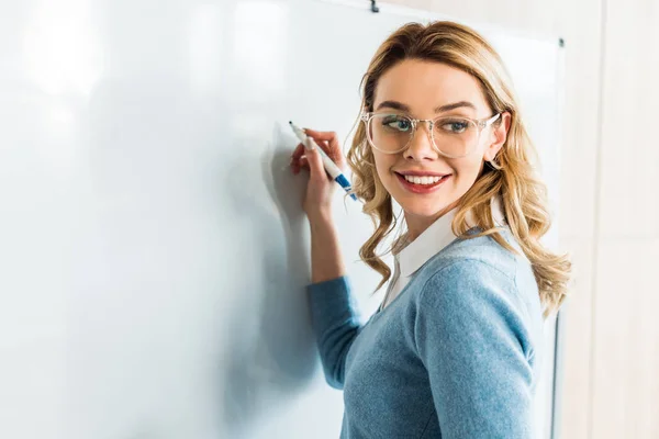 Smiling Blonde Student Glasses Writing Flipchart — Stock Photo, Image