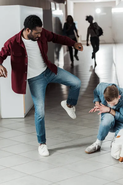 大学の廊下で戦うジーンズの2人の学生 — ストック写真