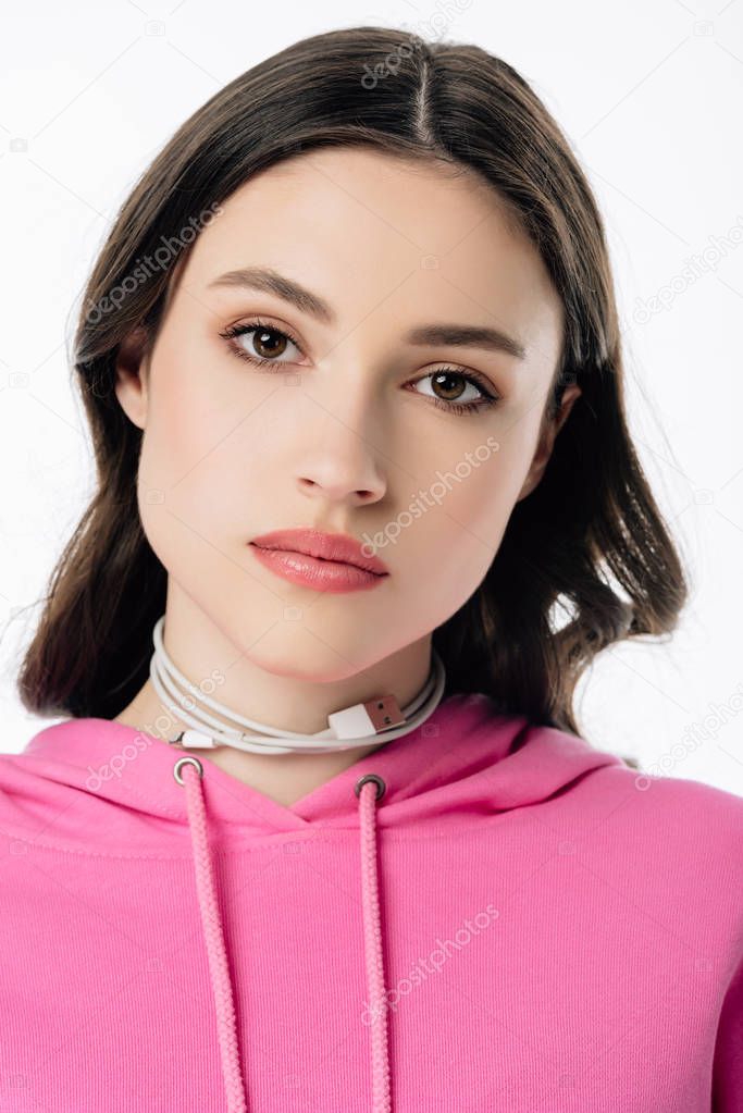 serious young girl with usb cable on neck looking at camera isolated on white