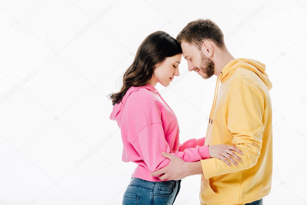 young couple standing face to face with closed eyes isolated on white