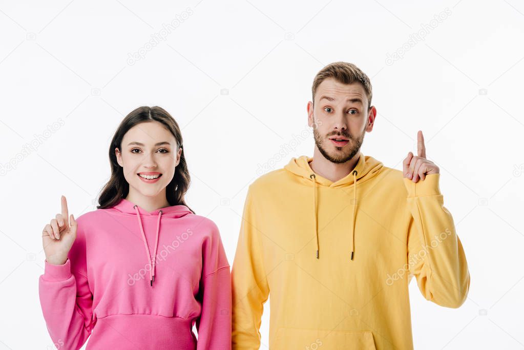 young smiling man and woman showing idea signs and looking at camera isolated on white