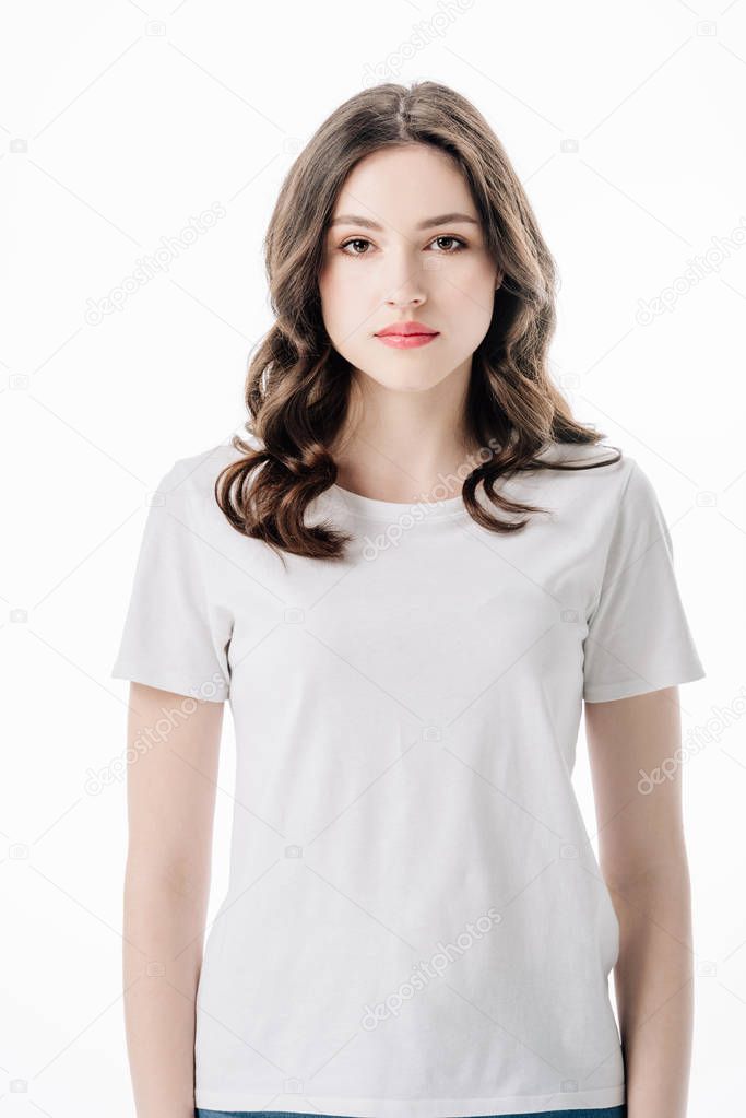 Beautiful serious girl in white t-shirt looking at camera isolated on white