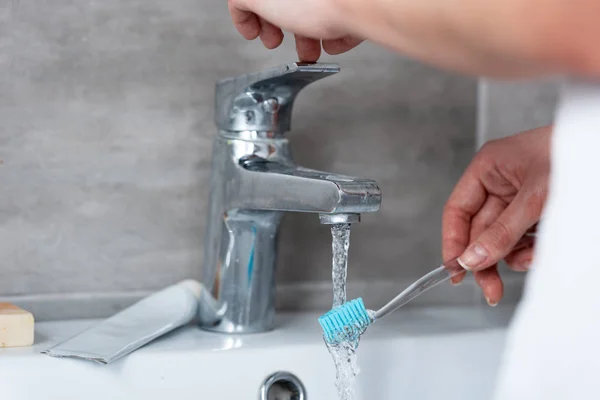 Partial View Woman Wetting Toothbrush Sink — Stock Photo, Image