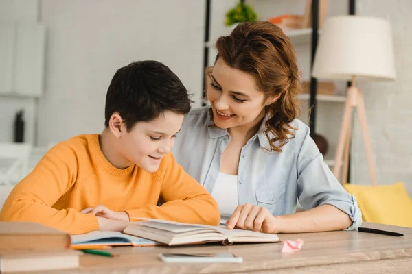 Smiling Mother Helping Adorable Son Doing Schoolwork Home — Stock Photo, Image