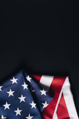 folded american national flag isolated on black, memorial day concept clipart