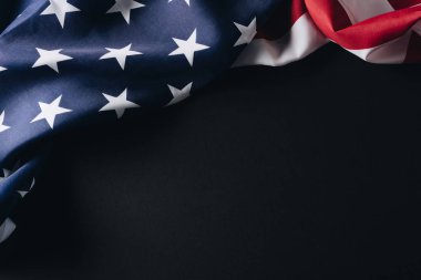 folded american national flag isolated on black, memorial day concept clipart