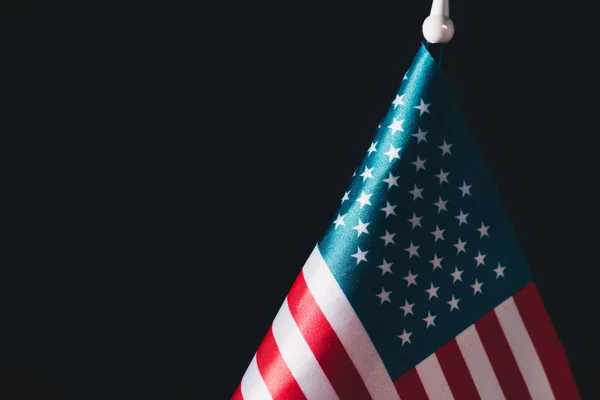 usa national flag on flagpole isolated on black, memorial day concept
