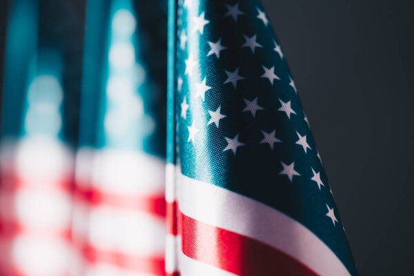 selective focus of united states national country flag isolated on black, memorial day concept