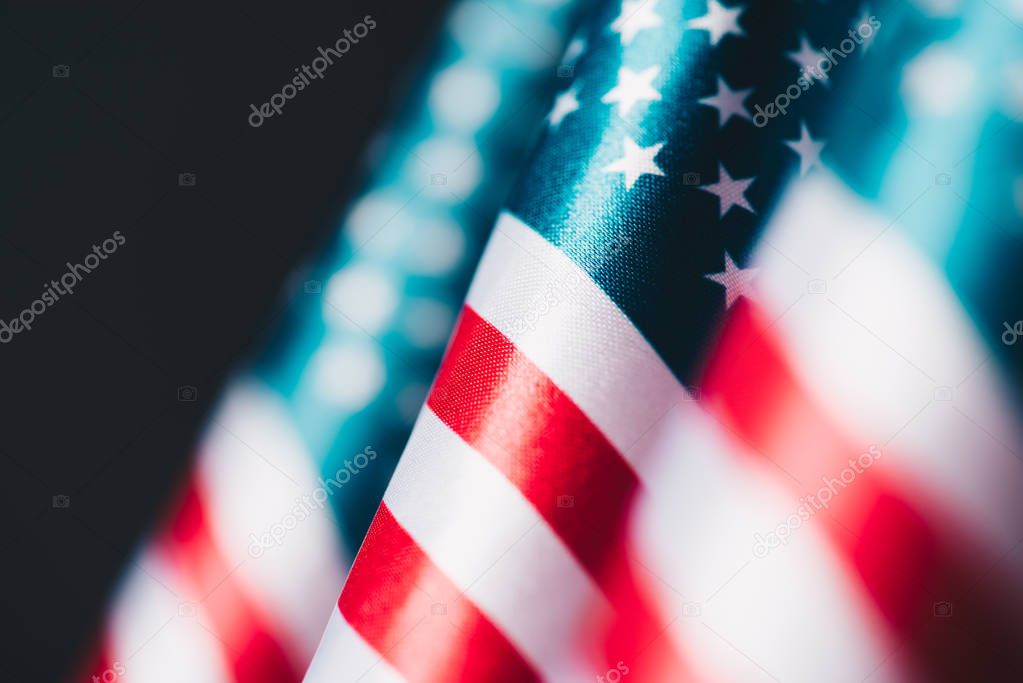 selective focus of united states of america national flags isolated on black, memorial day concept
