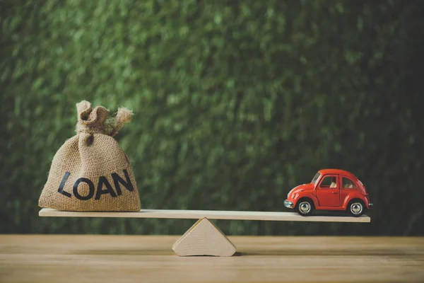 Red Miniature Car Money Bag Word Loan Balancing Seesaw Green — Stock Photo, Image