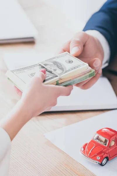 Cropped Shot Manager Taking Dollar Banknotes Client Red Toy Car — Stock Photo, Image