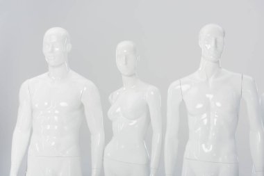 white plastic mannequin dolls isolated on grey  clipart