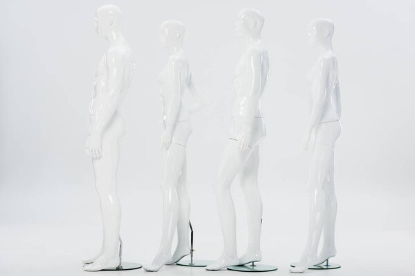 white plastic mannequins in row on white