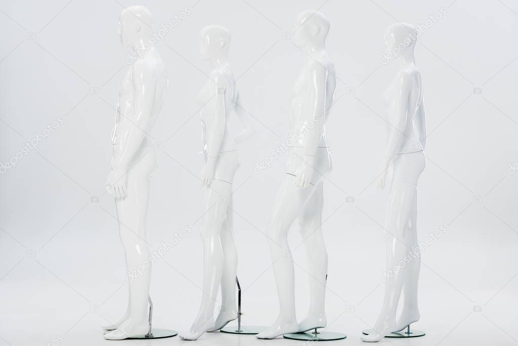 white plastic mannequins in row on white
