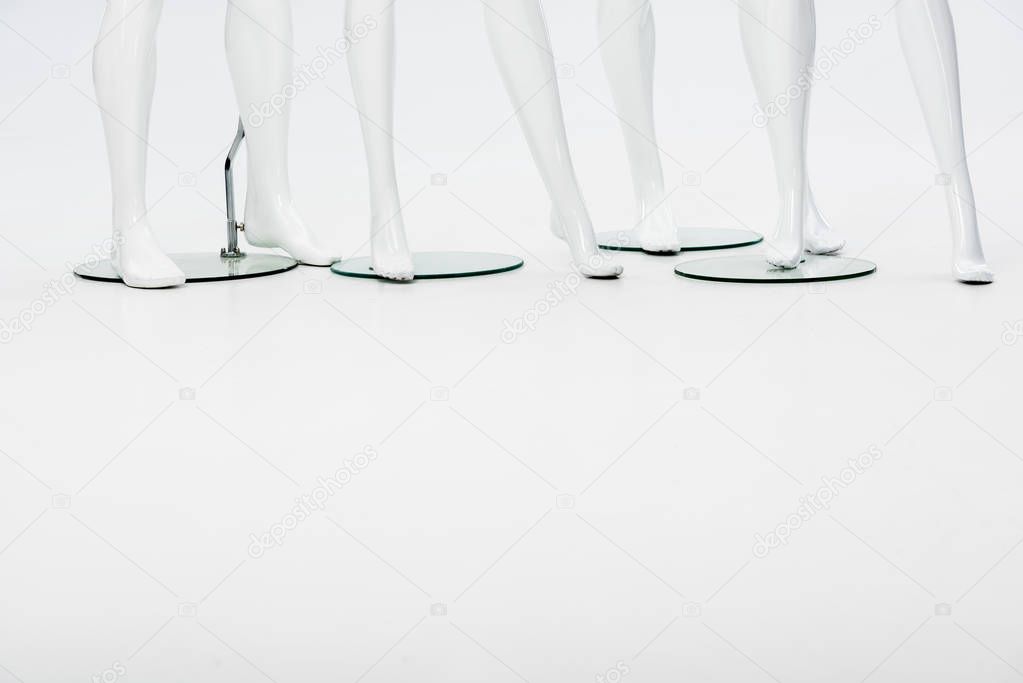 white plastic mannequin legs on white with copy space