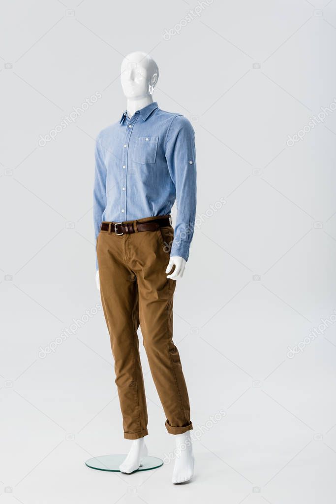 white plastic mannequin in clothes isolated on grey