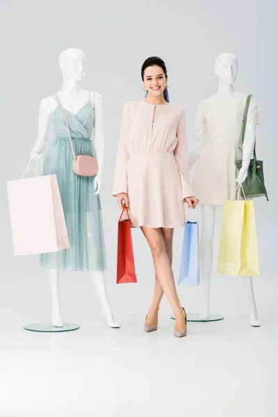 Beautiful Smiling Young Woman Shopping Bags Mannequins Grey — Stock Photo, Image