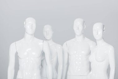 white plastic mannequin dummies isolated on grey  clipart