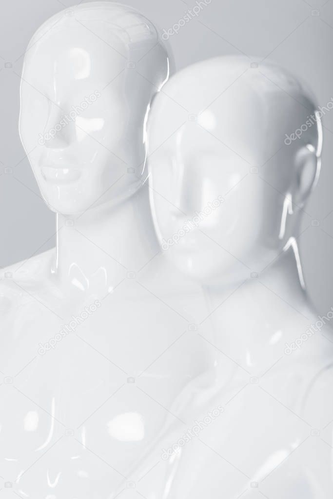 white plastic mannequin dummies isolated on grey 