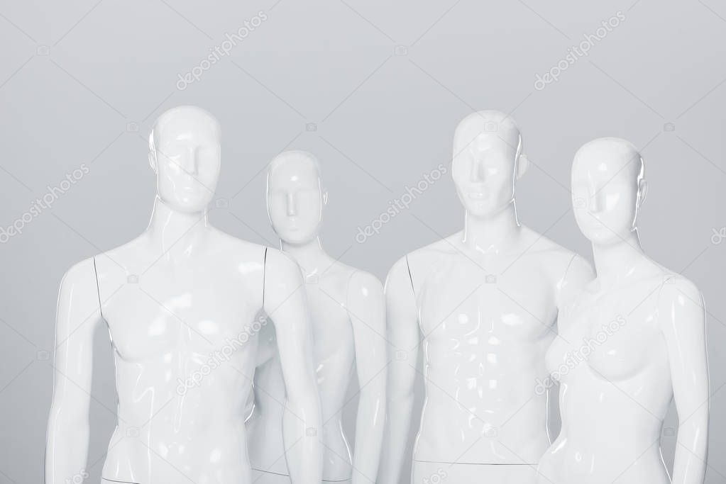 white plastic mannequin dummies isolated on grey 