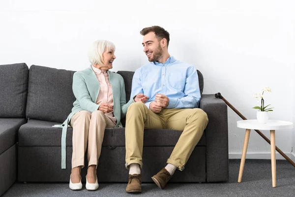 Smiling Senior Woman Son Looking Each Other While Sitting Sofa — Stock Photo, Image