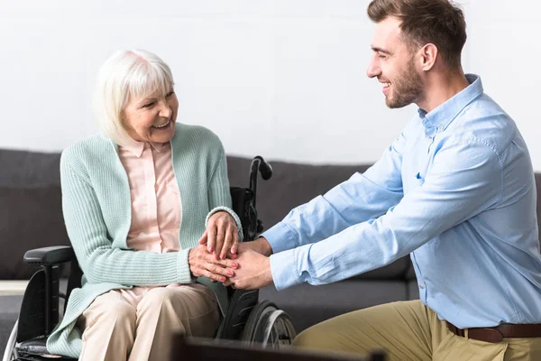 Smiling Bearded Man Holding Hands Disabled Senior Mother — Stock Photo, Image