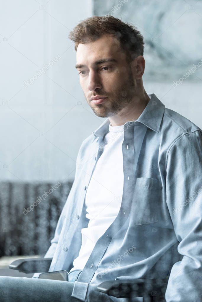 selective focus of sad disabled man on wheelchair