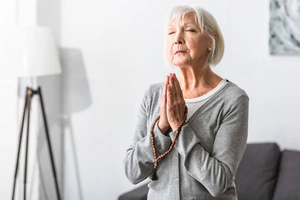 Senior Woman Holding Wooden Rosary Praying Closed Eyes — Stock Photo, Image
