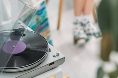 partial view of girl in dotted socks and record player with vinyl disc clipart