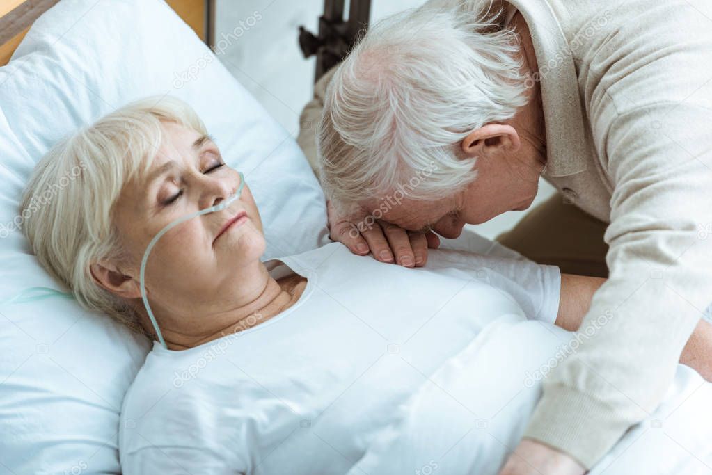 sad senior man and senior woman in coma in hospital
