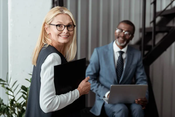 Selective Focus Happy Blonde Woman Holding Clipboard Smiling African American — Stock Photo, Image